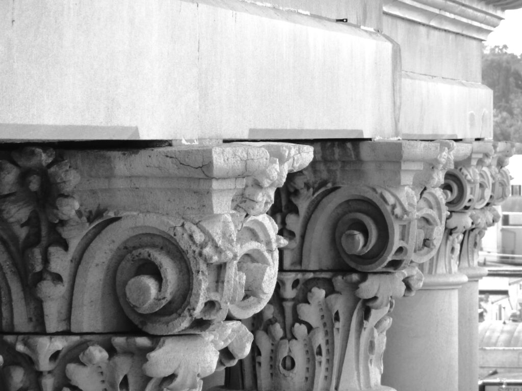 Black and white photo of elegant architectural columns showcasing intricate designs.